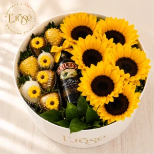 #186 Caja redonda con girasoles, fresas con chocolate y Media de Baileys